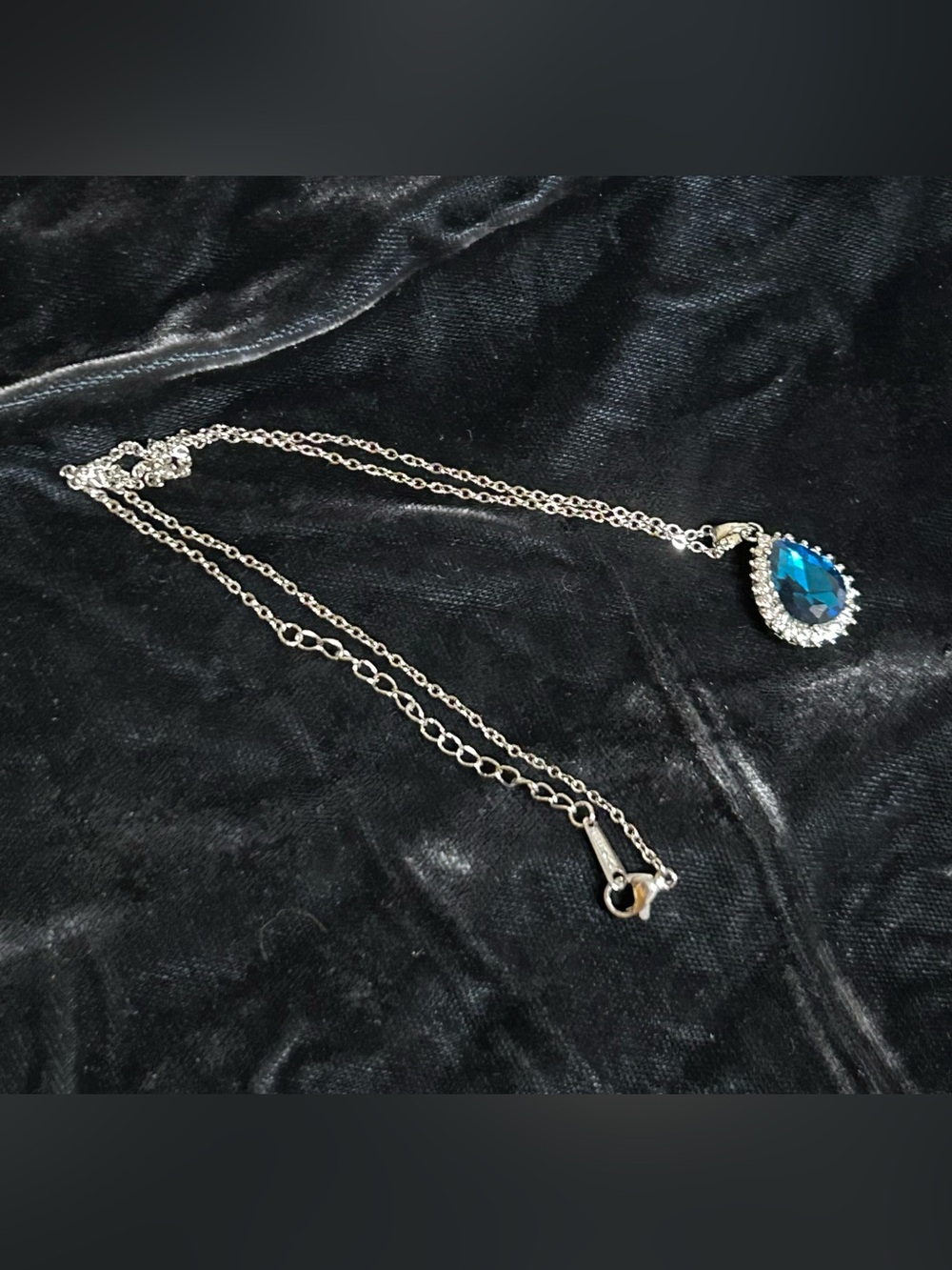 Silver Tone Necklace with Blue Teardrop Pendant and Crystal Halo